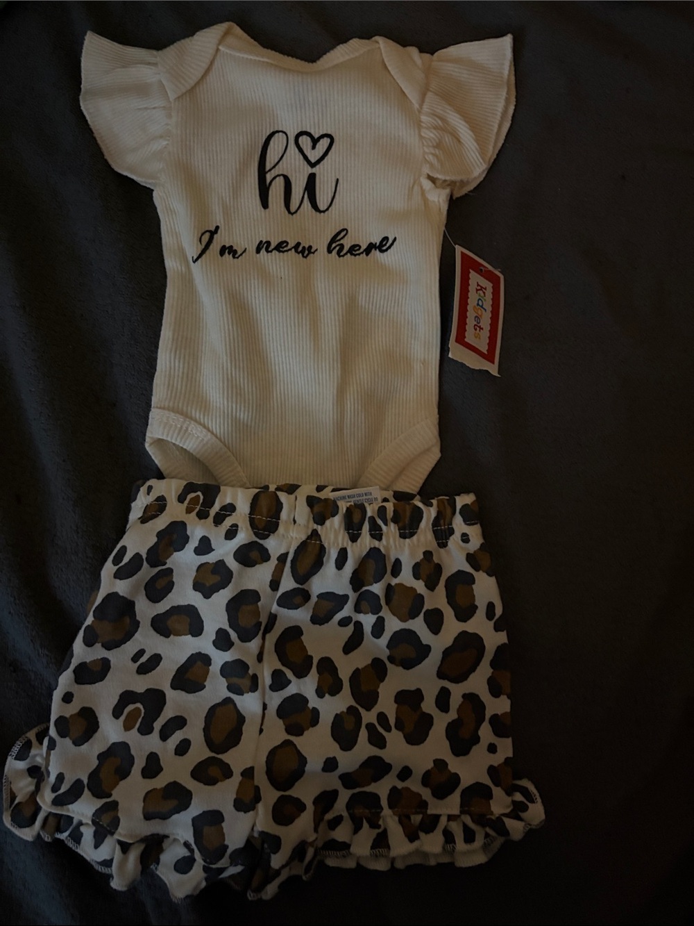 Kidgets White 'Hi I'm new here' Bodysuit with Leopard Print Shorts